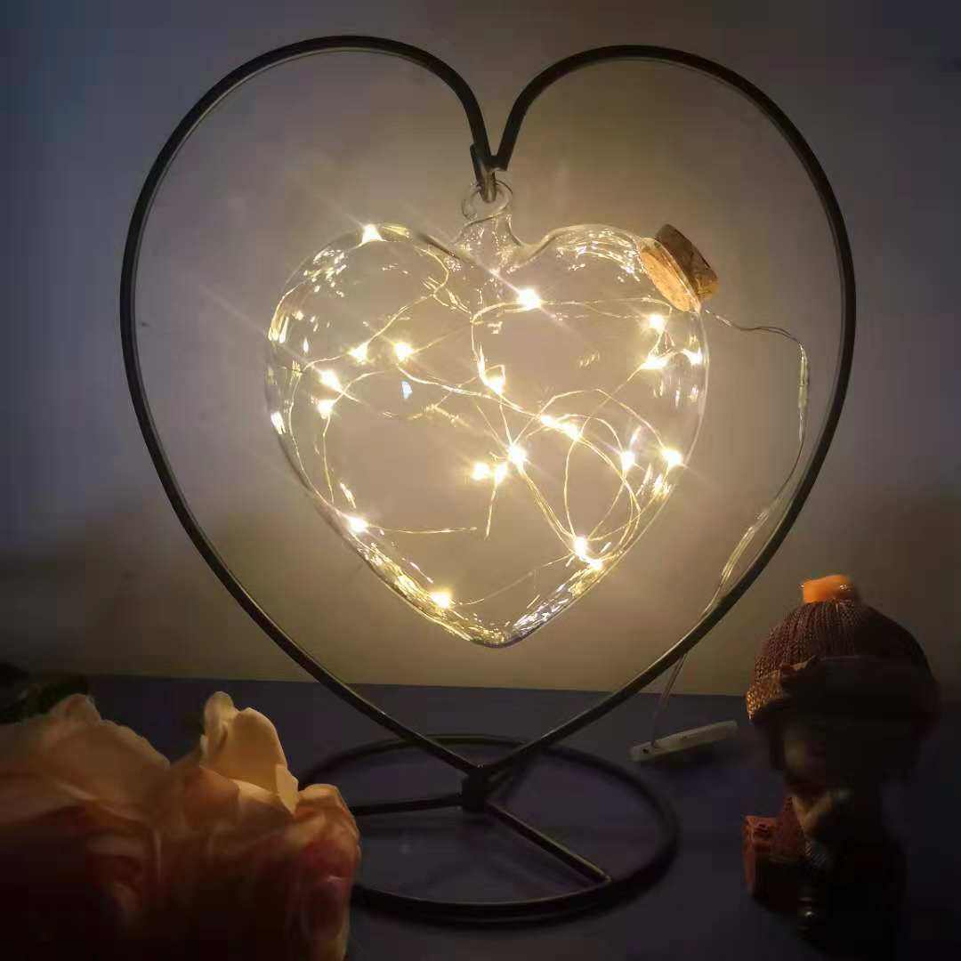 Gypsophila wishing bottle with warm white LED lights and decorative stars in a glass jar with cork stopper